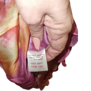 Tag showing fabric composition of Lipsy London silk dress – 100% silk shell