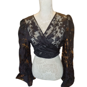 Black lace wrap top with floral sheer pattern and long sleeves on white mannequin